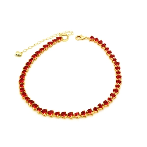Detail of gold heart tennis necklace with red zircon stones and lobster clasp closure