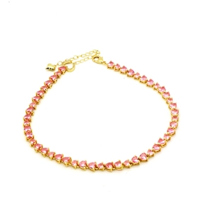Detail of pink heart-shaped zircon tennis bracelet in gold finish with extension chain