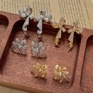 Bowknot earrings with cubic zirconia plating and pearl attachment loops in two colors