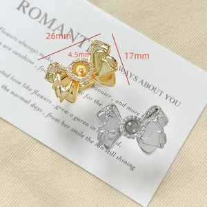 Macro view of 18k gold plated bow ring base with cubic zirconia and dimension labels
