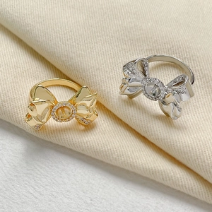 Detailed shot of bowknot rings with micro-set zircons in gold and silver finish
