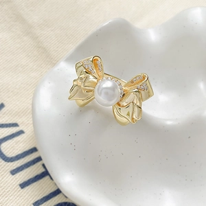 Elegant 18k gold plated bow ring with a white pearl and sparkling zircon accents