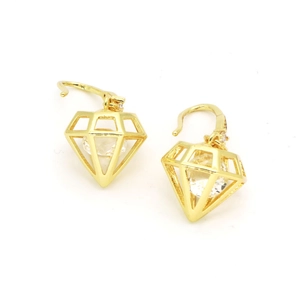 Close-up of golden hollow diamond frame earrings with sparkling zircon gemstone