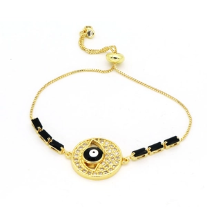 Macro detail of Evil Eye bracelet featuring gold box chain and adjustable slider clasp