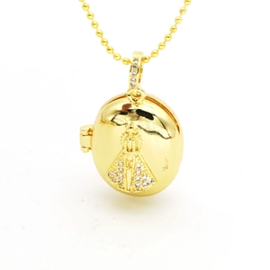 Macro view of gold religious locket with Virgin Mary relief and sparkling crystals