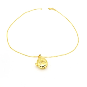 Close-up of gold ball chain necklace with openable locket and religious relief