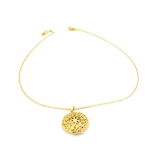 Detailed view of golden locket necklace featuring intricate hollow starburst engraving