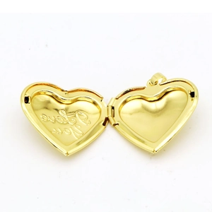 Macro detail of open gold heart locket showing I love you engraving and inner photo space