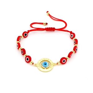 Adjustable red woven string Evil Eye bracelet with gold Love ring and blue bead charm