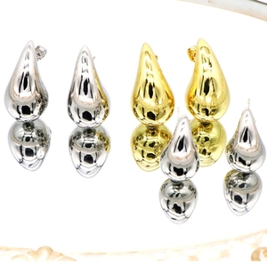 Polished hollow teardrop earrings in gold and silver finish with mirror reflections