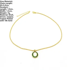 Detail of 18k gold plated copper necklace with white shell and green zircon pendant
