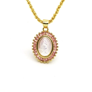 Macro detail of gold oval Virgin Mary pendant with purple zircon and twisted chain