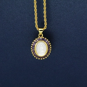 Close-up of gold virgin mary pendant with purple zircon and twisted rope chain