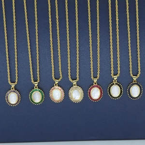 Detailed display of colorful zircon oval pendants with Mother Mary shell relief on rope chains