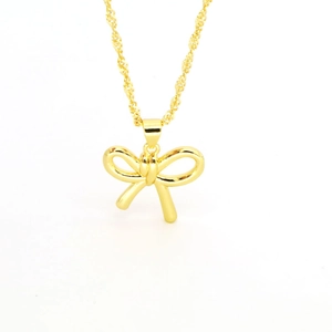 Close-up of golden bow pendant necklace with detailed sleek chain and ribbon design