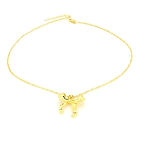 Close-up of gold bow pendant necklace with textured rope chain and adjustable clasp