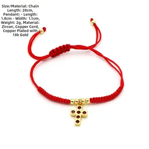 Detail of red woven bracelet with a 1.8cm gold-plated cross pendant and red zircons