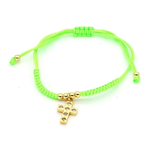 Neon green braided bracelet with zircon-encrusted gold cross charm and adjustable cord