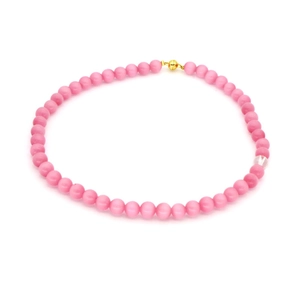 Pink agate bead necklace with a clear accent bead and golden clasp on a white background