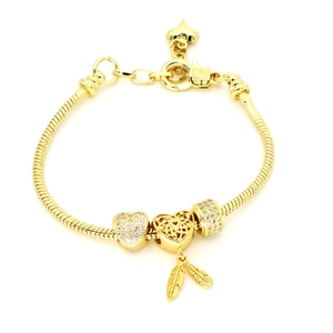 Gold plated snake chain bracelet featuring sparkling heart charms and feather pendants