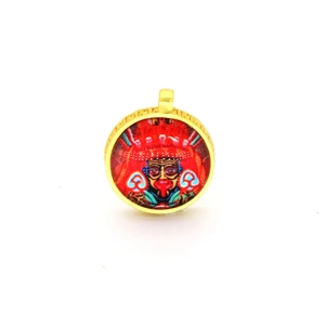 Ethnic round pendant featuring a colorful tribal mask with gold-textured metal frame