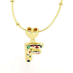 Close-up of gold plated letter F pendant with colorful zircon stones and heart buckle