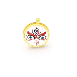 Detailed view of the gold-rimmed circular Thangka pendant with religious eye pattern