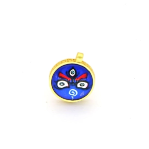 Detail of round golden pendant featuring traditional blue Thangka mask and meander patterns