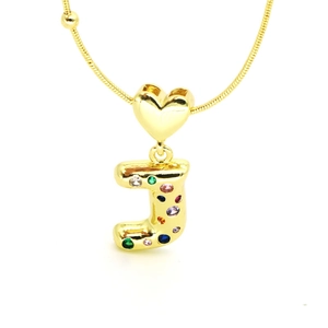 Macro shot of 18k gold heart necklace with colorful zircon letter J on snake chain