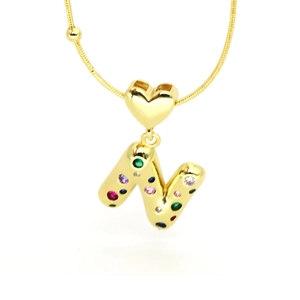 Macro detail of 18k gold plated letter N pendant with colorful crystals and heart clasp