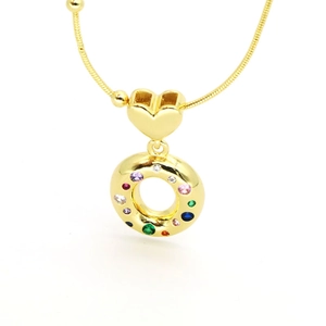 Macro shot of 18k gold plated necklace featuring a colorful zircon inlaid heart pendant