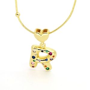 Close-up of golden letter R heart pendant with colorful zircon stones on snake chain