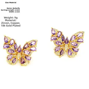 Detail of gold butterfly earring with purple zirconia stones measuring 2.0cm by 2.5cm