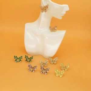 Detailed set of butterfly stud earrings with colorful cubic zirconia on display stand