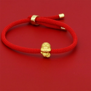 Handcrafted red woven bracelet with a golden zodiac snake charm and lucky coin bead