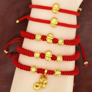 Handmade red cord bracelets with golden zodiac snake charms for Year of the Snake 2025