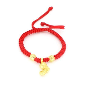 Macro detail of red woven bracelet with golden snake pendant and intricate beads