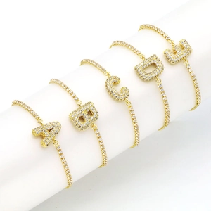 Detail of five 18k gold plated balloon initial bracelets with sparkling zircon stones