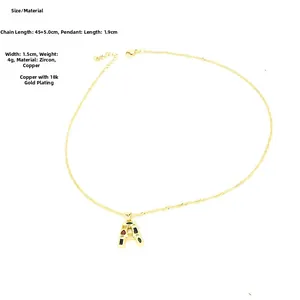 Detailed shot of letter A pendant with colorful zircons on 18k gold plated rope chain
