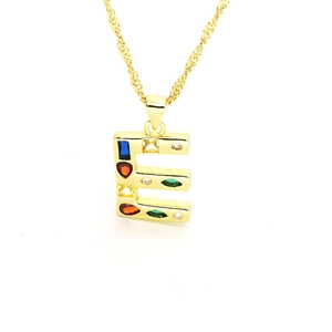 Detailed close-up of a gold-plated letter E pendant with vibrant colorful zircon stones