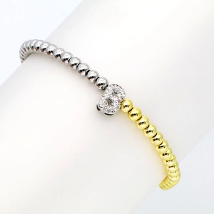 Close-up of 18k gold plated beaded bracelet with zircon-encrusted letter B charm