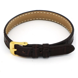 Detail of dark brown faux crocodile leather bracelet with gold buckle and white stitching