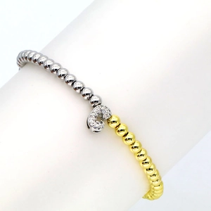 Detail of beaded stretch bracelet with gold and silver beads and crystal letter charm