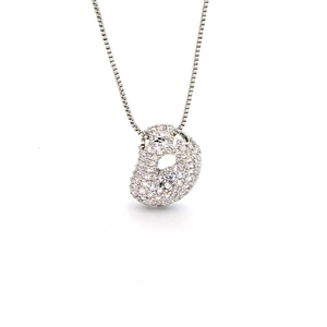 Detailed view of the sparkling cubic zirconia bean pendant on a polished box chain