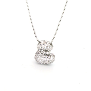 Macro shot of silver balloon bear pendant with zircon pave stones on a box chain necklace