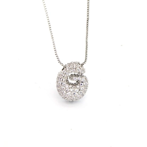 Close-up of zircon-encrusted capital G balloon pendant on a durable silver box chain