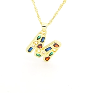 Detailed close-up of gold M letter pendant featuring colorful cubic zirconia stones