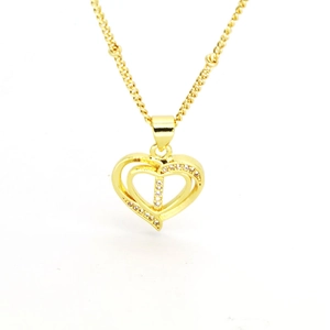 Macro shot of 18k gold heart pendant featuring sparkling zircon micro-paving on a fine chain