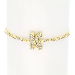 Detailed macro of 18k gold plated bracelet with sparkling zircon pavé letter K pendant