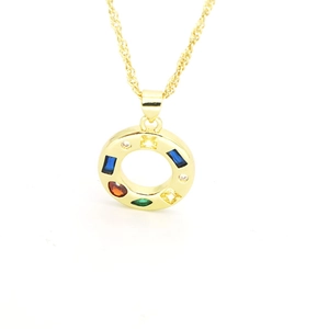 Macro detail of gold-plated pendant necklace with multi-colored cubic zirconia stones